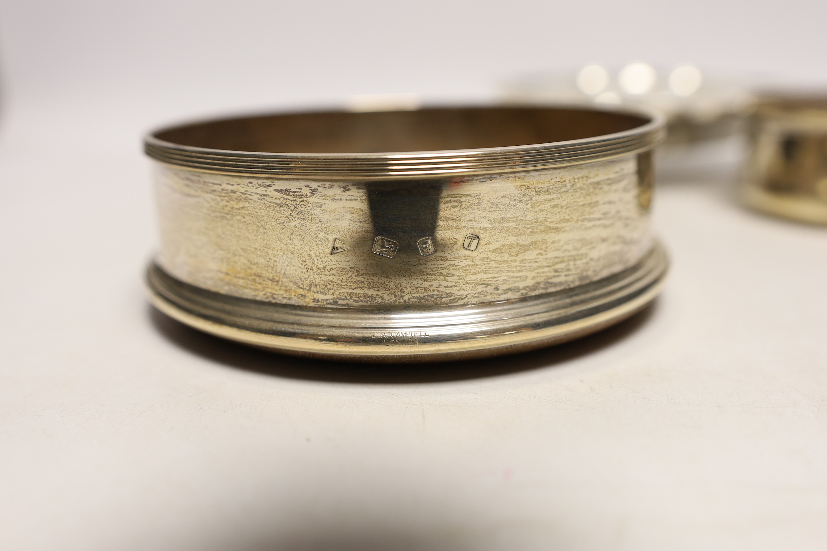 A small George V silver bowl, Sheffield, 1934, a silver bottle coaster, a small Indian white metal dish with inset rupee coin and a further small silver christening bowl.